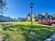 Landscaped lawn area with community buildings at 936 Birmingham Ct # 200, Lake Mary, FL 32746