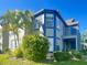 Two-story condo featuring blue and beige siding, a balcony, and lush landscaping, offering a charming curb appeal at 936 Birmingham Ct # 200, Lake Mary, FL 32746