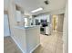 Open concept kitchen with stainless steel appliances and a breakfast bar overlooking the living area at 936 Birmingham Ct # 200, Lake Mary, FL 32746