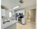 Bright kitchen with stainless appliances, tile flooring, and white cabinets at 936 Birmingham Ct # 200, Lake Mary, FL 32746