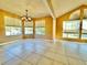 Spacious living room with tile flooring, a modern light fixture, and abundant natural light at 936 Birmingham Ct # 200, Lake Mary, FL 32746