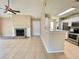Open living room with tile floors, fireplace, and seamless access to the kitchen at 936 Birmingham Ct # 200, Lake Mary, FL 32746