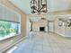 Open living room with tile flooring, recessed lighting, fireplace, and view to the kitchen at 936 Birmingham Ct # 200, Lake Mary, FL 32746