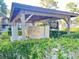 Mailbox station shaded by a wooden shelter with well-maintained surrounding greenery at 936 Birmingham Ct # 200, Lake Mary, FL 32746