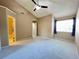 Spacious bedroom featuring neutral walls, carpet flooring, ensuite bathroom, and window at 936 Birmingham Ct # 200, Lake Mary, FL 32746