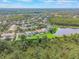 Aerial view of a residential community, lake, and lush green landscape at 9780 Cypress Pine St, Orlando, FL 32827