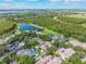 Aerial view of a residential community, lake, and lush green landscape at 9780 Cypress Pine St, Orlando, FL 32827
