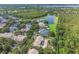 Aerial view of a residential community, lake, and lush green landscape at 9780 Cypress Pine St, Orlando, FL 32827