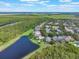 Aerial shot of homes near a winding lake surrounded by nature with clear blue skies at 9780 Cypress Pine St, Orlando, FL 32827