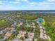 Breathtaking aerial view of residential area surrounded by lush greenery and sparkling lake at 9780 Cypress Pine St, Orlando, FL 32827