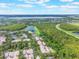 Panoramic aerial view of homes near a scenic lake, surrounded by trees and green space at 9780 Cypress Pine St, Orlando, FL 32827
