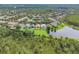 Beautiful aerial view of a neighborhood with lush greenery and a serene pond at 9780 Cypress Pine St, Orlando, FL 32827