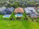 Aerial view of backyard pools and fenced yards surrounded by mature landscaping at 9780 Cypress Pine St, Orlando, FL 32827
