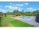 Spacious backyard with a pool, lounge area, and lush green grass, ideal for outdoor living at 9780 Cypress Pine St, Orlando, FL 32827