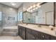Bright bathroom features a double vanity, soaking tub, and decorative accents at 9780 Cypress Pine St, Orlando, FL 32827