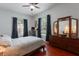 Bedroom featuring hardwood floors, natural light, and a decorative dresser at 9780 Cypress Pine St, Orlando, FL 32827