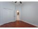 Bedroom featuring hardwood floors and closet with white doors at 9780 Cypress Pine St, Orlando, FL 32827
