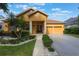 Charming home featuring a welcoming front entrance, two-car garage, and appealing landscaping at 9780 Cypress Pine St, Orlando, FL 32827