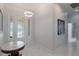 Bright foyer featuring marble floors, elegant lighting, and a decorative glass front door at 9780 Cypress Pine St, Orlando, FL 32827