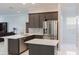 Beautiful kitchen featuring quartz countertops, stainless steel appliances, and dark wood cabinets at 9780 Cypress Pine St, Orlando, FL 32827
