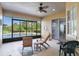 Enclosed patio featuring a ceiling fan and outdoor seating with a view of the pool at 9780 Cypress Pine St, Orlando, FL 32827
