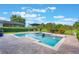 An inviting pool with water features on a sunny day, framed by a well-maintained patio at 9780 Cypress Pine St, Orlando, FL 32827