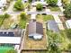 Aerial view of home with a neutral roof, fenced backyard, and street in the background at 9821 8Th Ave, Orlando, FL 32824