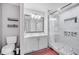 Bathroom featuring white cabinets, double sinks, a large framed mirror, and a walk-in glass shower at 9821 8Th Ave, Orlando, FL 32824