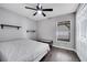 Bedroom with gray walls, wood-look flooring, and a large window that provides ample natural light at 9821 8Th Ave, Orlando, FL 32824