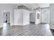 Bright, open living room with light gray walls, archways, and wood-look flooring at 9821 8Th Ave, Orlando, FL 32824