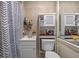 Small bathroom featuring a white vanity, shower-tub combination, with neutral tilework and a bright, minimalist feel at 985 N Village Dr, Deltona, FL 32725