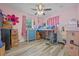 Whimsical pink bedroom with charming details, including a loft bed and lots of storage, creates a playful, fun space at 985 N Village Dr, Deltona, FL 32725