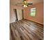 Bedroom featuring new floors, a window, and a closet with sliding doors at 985 N Village Dr, Deltona, FL 32725