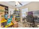 Bright bedroom featuring a desk and natural light streaming through windows; ideal for a home office or student at 985 N Village Dr, Deltona, FL 32725