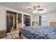 Bedroom featuring a spacious closet with wood-look floors, a ceiling fan, and storage for organized, clutter-free living at 985 N Village Dr, Deltona, FL 32725