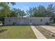 Charming single-story home featuring a well-maintained lawn and a classic brick facade at 985 N Village Dr, Deltona, FL 32725
