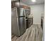Modern kitchen featuring stainless steel appliances, granite countertops, and wood cabinets at 985 N Village Dr, Deltona, FL 32725