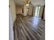 Bright living room showcasing new flooring, large window, and a ceiling fan at 985 N Village Dr, Deltona, FL 32725