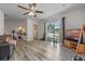 Open-concept living area with a large window, new flooring, and seamless access to other spaces at 985 N Village Dr, Deltona, FL 32725