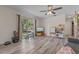 Bright and airy living room with a large window, new flooring, and a ceiling fan at 985 N Village Dr, Deltona, FL 32725