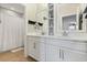 Bathroom featuring white double vanity sinks with modern finishes and shower at 9873 Lost Creek Dr, Winter Garden, FL 34787