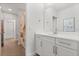 Clean bathroom featuring modern vanity, large mirror, and neutral tile floor at 9873 Lost Creek Dr, Winter Garden, FL 34787