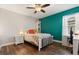 Charming bedroom with a bright green accent wall and wood flooring at 9873 Lost Creek Dr, Winter Garden, FL 34787
