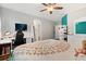 Bright bedroom featuring hardwood floors, mounted tv, and a modern desk at 9873 Lost Creek Dr, Winter Garden, FL 34787