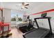 Bright bedroom featuring a ceiling fan, gray and white striped walls and a comfortable bed, plus fitness equipment at 9873 Lost Creek Dr, Winter Garden, FL 34787