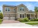 Beautiful two-story home with a two-car garage, solar panels, well-kept lawn and a brick-paved driveway at 9873 Lost Creek Dr, Winter Garden, FL 34787