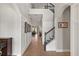 Elegant foyer featuring wood floors, staircase with iron railings, and soaring ceilings for a grand entrance at 9873 Lost Creek Dr, Winter Garden, FL 34787