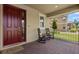 Inviting front porch with rocking chairs and a brick floor for a relaxing outdoor experience at 9873 Lost Creek Dr, Winter Garden, FL 34787