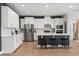 Modern kitchen featuring white cabinets, stainless steel appliances, and bar seating for a contemporary look at 9873 Lost Creek Dr, Winter Garden, FL 34787