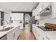 Bright kitchen featuring white cabinetry, stainless appliances, and sleek quartz countertops at 9873 Lost Creek Dr, Winter Garden, FL 34787